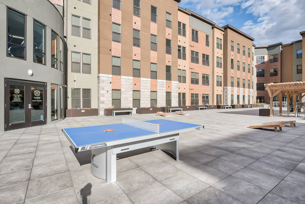 outdoor community area with a ping pong table at roam student apartments