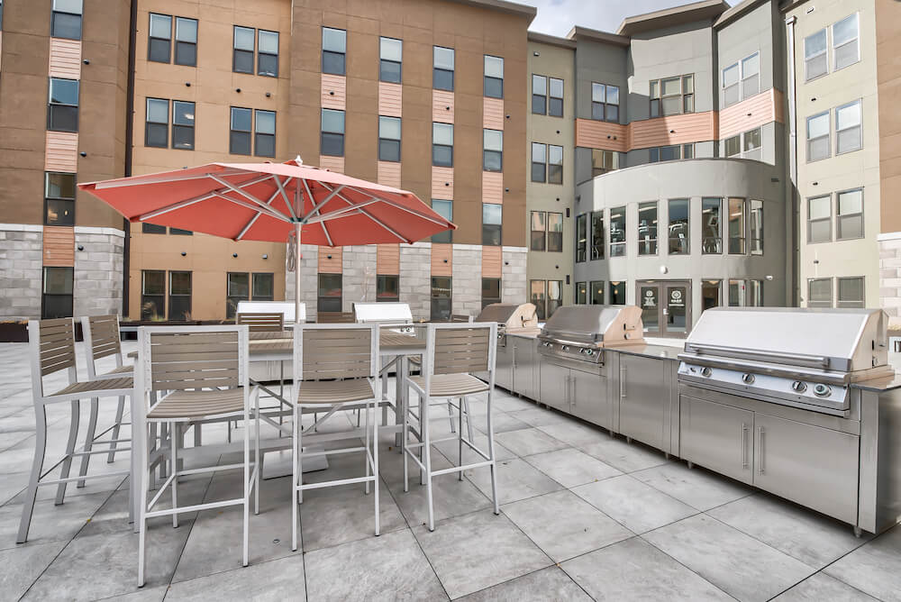 outdoor community area and grills at roam apartments